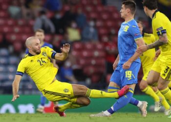 PERTAHANAN Sweden, Marcus Danielsson (kiri) dilayangkan kad merah selepas mengasari Artem Besyedin dalam saingan 16 pasukan terakhir Euro 2020 di Hampden Park, Glasgow, hari ini.- AFP