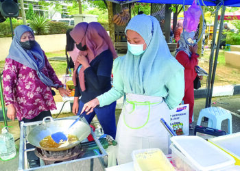 SITI SYAZWANI Zanim menjual pisang goreng semasa menyertai Karnival Jualan Usahawan Bimbingan Kemas di Menara Persekutuan, Ayer Keroh, Melaka. - UTUSAN/AMRAN MULUP