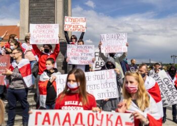 PESERTA protes memegang sepanduk dan bendera Belarus
semasa menyertai demonstrasi di Castle Square, Warsaw,
Poland. – AFP