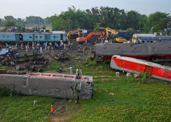 PASUKAN polis memeriksa gerabak kereta api yang bertembung di Odisha. - AFP