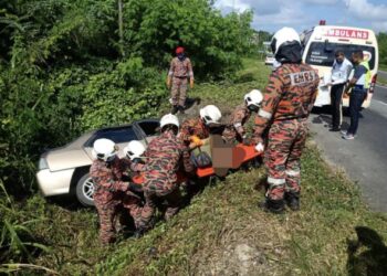 PASUKAN bomba membantu mengeluarkan mangsa yang maut selepas kenderaan terbabas dalam parit di Batu 11, Jalan Seguntur, Sandakan hari ini.-IHSAN Bomba