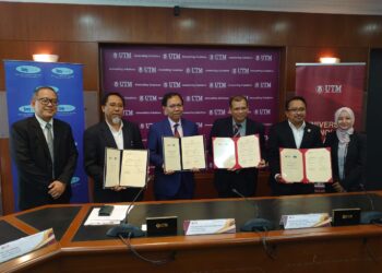 DR. AIZAI AZAN ABDUL RAHIM (tiga kiri) bertukar dokumen dengan Rosli pada Majlis Menandatangani MoU dan MoA antara IJN dan UTM di UTM Skudai, Johor Bahru.