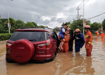 PASUKAN penyelamat memindahkan penduduk dari kawasan banjir selepas Taufan Doksuri melanda Quanzhou, wilayah Fujian, timur China.- AFP