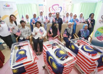 SITI Mariam Ali (tengah) bersama Yayasan Kita Anak Malaysia dan kakitangan Hospital Shah Alam meraikan kelahiran ‘anak merdeka’ dekat wad bersalin hospital berkenaan di Shah Alam, Selangor. - UTUSAN/AFIQ RAZALI