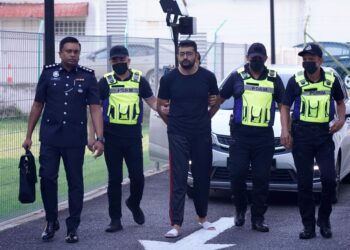 MOHAMED Imran Mohamed Yunos dibawa oleh anggota polis ke Mahkamah Majistret Kajang bagi menghadapi pertuduhan membunuh isterinya. -UTUSAN/FAUZI BAHARUDIN