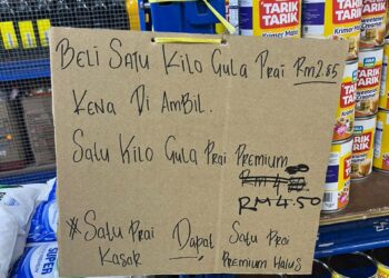 NOTIS diletakkan peniaga yang mengenakan syarat pembelian gula dikesan di sebuah kedai di Batu Gajah. - UTUSAN