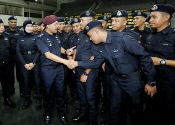 MOHD. Yusri Hassan Basri  (kiri) bersalam dengan pegawai dan anggota polis Perak pada Majlis Pelepasan Bantuan Sumber Manusia PDRM Perak yang bertugas di PRN Kelantan di Ipoh hari ini. -UTUSAN/MUHAMAD NAZREEN SYAH MUSTHAFA