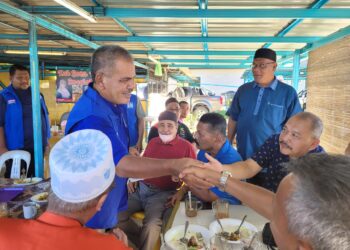 AHMAD Deraman (kiri) beramah mesra dengan pengundi semasa turun berkempen di Kampung Batu Tinggi di Kok Lanas, Kota Bharu, Kelantan hari ini. UTUSAN/MUSTAQIM MOHAMED