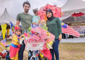 NOOR FAZIELAH KAMISAN bersama suami dan dua anaknya pada Sambutan Bulan Kemerdekaan Ke-66 Taman Bukit Tambun Perdana, Durian Tunggal, Melaka. - UTUSAN/MUHAMMAD SHAHIZAM TAZALI