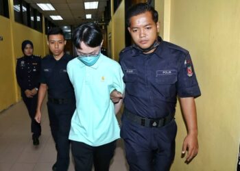 LIEW Ming Hui (tengah) didakwa memiliki bahan pornografi kanak-kanak ketika didakwa di Mahkamah Majistret  Teluk Intan hari ini. - UTUSAN/MUHAMAD NAZREEN SYAH MUSTHAFA