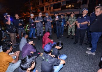 AMINUDDIN Harun (kanan) turun padang mengetuai penguatkuasaan Op Sabong yang turut menyasarkan warga asing di kawasan Nilai, Seremban, semalam.-UTUSAN/MOHD. SHAHJEHAN MAAMIN.