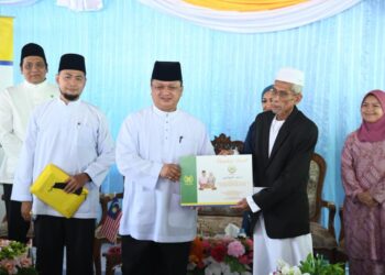 TUANKU Syed Faizuddin Putra Jamalullail berkenan mengurniakan sumbangan MAIPs kepada imam, Hussin Sanpit, di Masjid Muoleheem Islaam, Trang, Thailand, hari ini.- UTUSAN/IZLIZAN OTHMAN