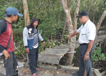 TAJUDIN Othman (kanan), Mohd. Razi Rahman (kiri) dan Mohd. Nor Mohd. Yusof menunjukkan Jeti Nelayan Kampung Jeram Batu, Pekan Nanas, Pontian, Johor, yang perlu dinaik taraf.