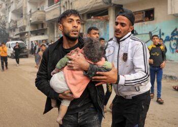 SEORANG lelaki mendukung kanak-kanak yang cedera akibat serangan udara tentera Israel di Rafah, selatan Semenanjung Gaza, Palestin. - AFP