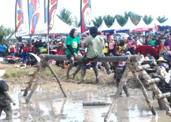 DUA peserta wanita menyertai acara pukul bantal atas tiang di Karnival D’Bendang, Kampung Parit Penghulu Benteng, Jasin, Melaka. - UTUSAN/AMRAN MULUP