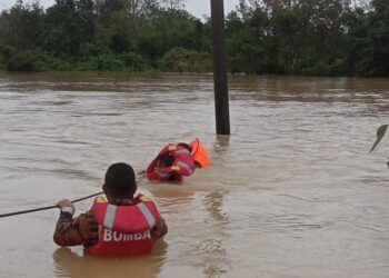 ANGGOTA Bomba dan Penyelamat berusaha menyelamatkan remaja yang dihanyutkan arus banjir di Kampung Mengketil, Machang, Kelantan-IHSAN BOMBA KELANTAN.