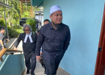 EBIT Lew bersama peguamnya semasa tiba di Mahkamah Majistret Tenom, hari ini