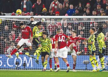 PENAJAGA gol Arsenal, David Raya cuba mengeluarkan bola dari kawasan bahaya ketika diasak jentera serangan Nottingham Forest dalam saingan Liga Perdana Inggeris, semalam. Arsenal menang 2-1. – AFP