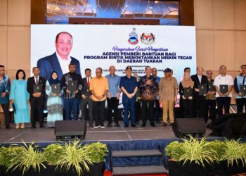 HAJIJI Noor (tengah) bersama wakil-wakil kementerian dan agensi kerajaan yang terlibat dalam program menoktahkan miskin tegar di negeri Sabah di Tuaran semalam.