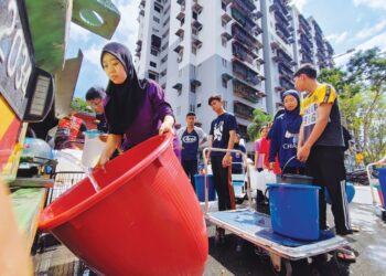 PENDUDUK di pangsapuri Taman Sri Bayu, Bayan Lepas, Pulau Pinang beratur mendapatkan bekalan air daripada lori tangki yang disediakan pihak berwajib susulan gangguan air di kawasan mereka sejak, kelmarin. - UTUSAN/IQBAL HAMDAN