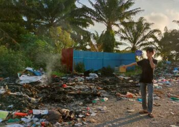 MOHD. Ali Shahbuddin menunjukkan tong sampah pukal yang tidak dapat menampung sampah dibuang di Tapak Pengumpulan Sampah Kawasan Kampung Tradisi, Sungai Kroh, Jalan Ipoh - Kampar. - UTUSAN/MEGAT LUTFI MEGAT RAHIM