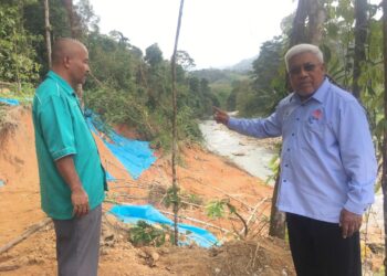 ABDUL Hadi Awang Kechik (kanan) menunjukan kawasan tanah runtuh yang berlaku di kawasan Dewan Undangan Negeri (DUN) Kuala Balah, Jeli, Kelantan-UTUSAN/ROSMIZAN RESDI.