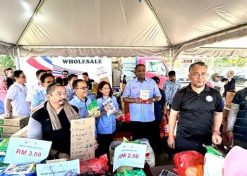 RAMANAN (tengah) beramah mesra dengan penduduk setempat ketika jualan Happy Hour yang berlangsung selama satu jam pada program JKMU, di sini