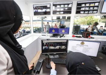 DUA kakitangan melakukan pemantauan calon yang melakukan latihan menggunakan eTesting di Institut Memandu Surfine Hi Tech di Hulu Langat. –  UTUSAN/MUHAMAD IQBAL ROSLI