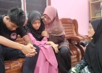 NUR Alwani Fatihah dan abangnya, Muhd Alif Farhan ditenangkan oleh ibu saudara mereka ketika ditemui di Selama. - UTUSAN/WAT KAMAL ABAS