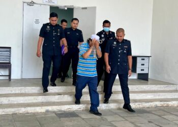 PENJUAL ketam (dua dari kanan) dibawa keluar dari Kompleks Mahkamah Kangar selepas menghadapi pertuduhan menghina Raja Perlis pada 6 Mac lalu di Mahkamah Sesyen, Kangar, Perlis hari ini. -UTUSAN/ASYRAF MUHAMMAD