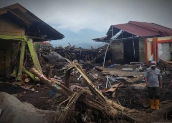 SEORANG penduduk berjalan berhampiran rumah yang musnah di kampung Bukik Batabuah, di daerah Agam, Sumatera Barat.-AGENSI