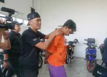 TERTUDUH semasa dibawa polis untuk prosiding pertuduhan di Mahkamah Sesyen, Kota Bharu, Kelantan hari ini-UTUSAN/ROSALWANI CHE SOH