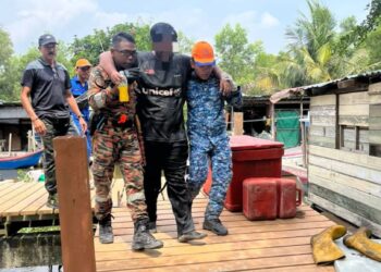 MUHAMMAD AZFAR (tengah) dipapah oleh anggota yang terlibat dalam operasi mencari dan menyelamat (SAR) ketika dijumpai selepas dilaporkan hilang sejak Sabtu lalu semasa mendaki bukit Hill Top di Batu Kawan, Pulau Pinang