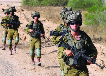 Israeli army soldiers patrol around a position along Israel's southern border with the Gaza Strip on June 13, 2024, amid the ongoing conflict between Israel and Hamas. (Photo by JACK GUEZ / AFP)