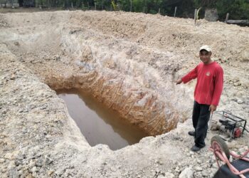 Rusli Che Kecik menunjukkan telaga ‘gergasi’ yang digalinya  untuk mendapat bekalan air ketika musim kemarau.