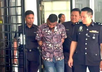 TERTUDUH (dua dari kiri) dibawa keluar selepas dituduh di Mahkamah Majistret Raub di Raub, Pahang.