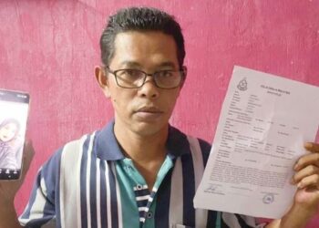 ABDUL Rahman Jaafar menunjukkan laporan polis dan foto anaknya yang hilang selepas keluar dari rumah mereka di Taman Lembah Bujang, Bedong, Sungai Petani, Kedah.