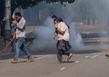 PENUNJUK perasaan menyelamatkan diri selepas polis melepaskan gas pemedih mata semasa demontrasi antikuota di Universiti Dhaka.- AGENSI