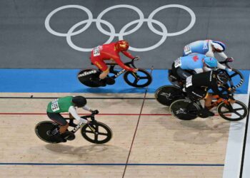 MUHAMMAD Shah Firdaus Sahrom (baju hitam) ketika mendapat tempat pertama pada aksi pusingan pertama repechage keirin lelaki di Velodrom Saint-Quentin-en-Yvelines, hari ini. - AFP