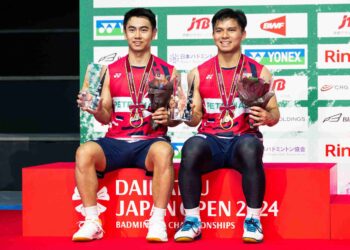 GOH Sze Fei (kanan) dan Nur Izzuddin bergambar di podium selepas kemenangan mereka menentang pemain Korea Selatan, Kang Min Hyuk dan Seo Seung Jae semasa perlawanan akhir beregu lelaki kejohanan badminton Terbuka Jepun di Arena Yokohama, minggu lalu. - AFP