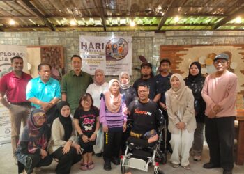 Ally Isyraf (berdiri, lima dari kanan) bersama Pengerusi Program Eksplorasi Belia OKU @Langkawi, Suraya Saad (berdiri, empat dari kiri), bergambar bersama sebahagian peserta OKU dan urus setia semasa Program Penutup yang diadakan di Pantai Tengah, di sini semalam