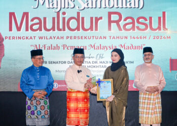 MOHD. Na’im Mokhtar menyampaikan anugerah khas Sambutan Maulidur Rasul Peringkat Wilayah Persekutuan Kuala Lumpur kepada wartawan Utusan Malaysia, Nurul Irdina Sumali yang mewakili Maisarah Sheikh Rahim, hari ini.