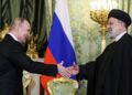 PRESIDEN Russia, Vladimir Putin (kiri) berjabat tangan dengan Presiden Iran, Ebrahim Raisi semasa pertemuan mereka di Kremlin, Moscow pada 7 Disember 2023.- AFP