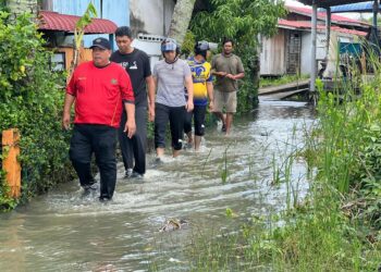 ABU Bakar Hamzah (depan) turun padang meninjau mangsa-mangsa banjir yang terjejas berikutan fenomena air pasang di sekitar Kuala Perlis, Perlis, hari ini. -UTUSAN/ASYRAF MUHAMMAD