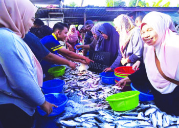 ORANG ramai memilih ikan yang dijual dengan harga 20 sen seekor di Pasar Tikam Batu, Sungai Petani. - UTUSAN/ OTHMAN YAHAYA