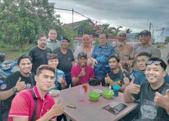 AHMAD Maslan (berdiri, tiga dari kanan) bersama-sama penduduk selepas melakukan Ziarah Kasih di Kampung Melayu Timur 2, Kluang.