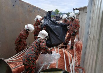 ANGGOTA bomba mengangkat mayat Kali Muthu Baskaran yang maut selepas lori kargo yang dinaiki merempuh sebuah lori yang rosak di KM 257.89, LPT2 berhampiran Hentian R&R Perasing, Kemaman, hari ini.