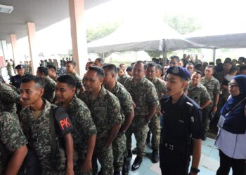 SEBAHAGIAN anggota tentera beratur menunaikan tanggungjawab sebagai pengundi pada hari mengundi  awal bagi PRK DUN Mahkota di Dewan Mahkota, Kem Mahkota, Kluang.