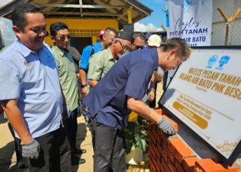 MUHAMMAD Faiz Fadzil (kanan) meletakkan batu asas sebagai simbolik perasmian Majlis Pecah Tanah Kilang Air Batu PNK Besut sempena Program Ramah Mesra Madani di Kuala Besut, Besut, hari ini. - UTUSAN/ZAID MOHD NOOR