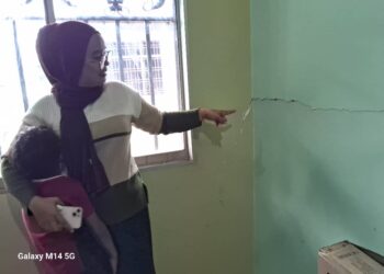 NORAFIDAH Mohd. Suki menunjukkan rekahan dinding di rumahnya di Taman Sempalit Permai, Mentakab semalam.